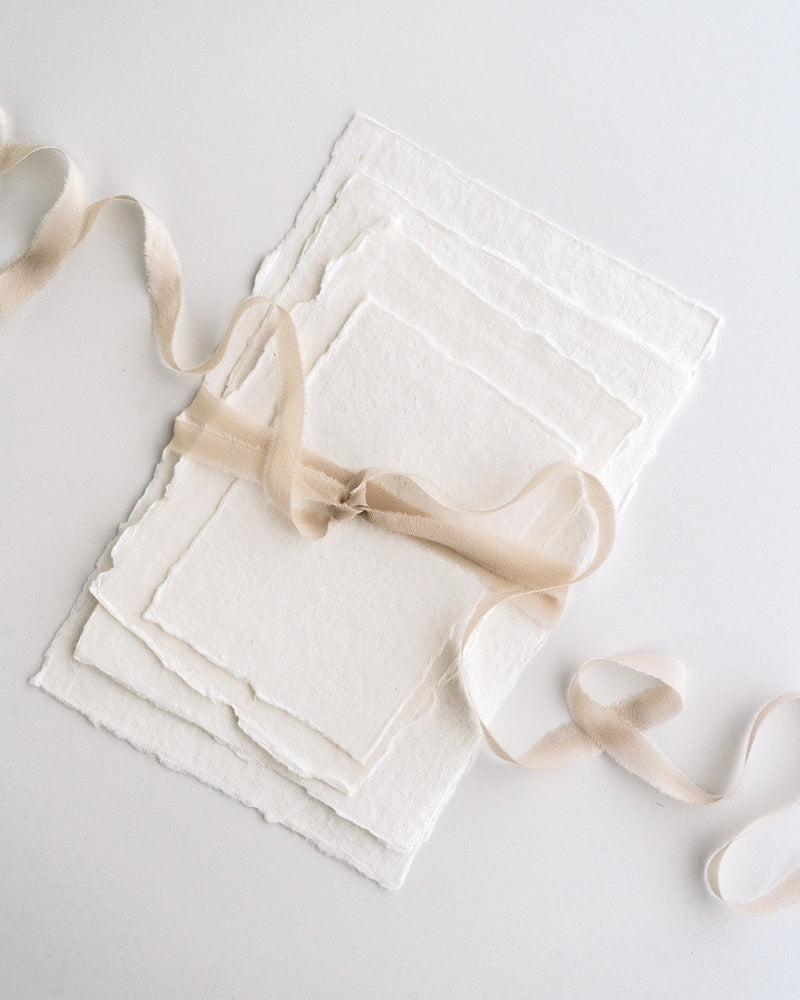 Tono + co Silk Ribbon Trim in Bone. Perfect for stationary styling, boutonnieres, and detail work. Find your inspiration through color and silk. Lovingly hand-dyed in Santa Ana, California and available in 24 signature colors. Check out our website for more styling, flat-lay, and color tips.