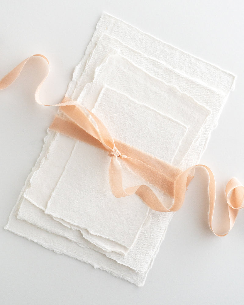 Tono + co Silk Ribbon Trim in Peach. Perfect for stationary styling, boutonnieres, and detail work. Find your inspiration through color and silk. Lovingly hand-dyed in Santa Ana, California and available in 24 signature colors. Check out our website for more styling, flat-lay, and color tips.