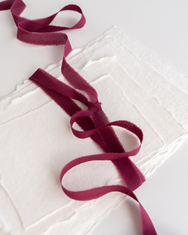 Tono + co Silk Ribbon Trim in Berry. Perfect for stationary styling, boutonnieres, and detail work. Find your inspiration through color and silk. Lovingly hand-dyed in Santa Ana, California and available in 24 signature colors. Check out our website for more styling, flat-lay, and color tips.