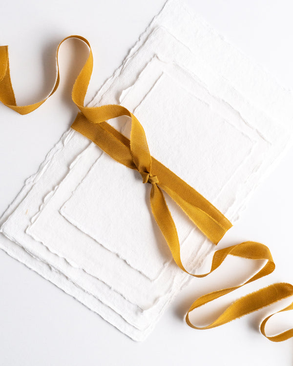 Tono + co Silk Ribbon Trim in Oro. Perfect for stationary styling, boutonnieres, and detail work. Find your inspiration through color and silk. Lovingly hand-dyed in Santa Ana, California and available in 24 signature colors. Check out our website for more styling, flat-lay, and color tips.
