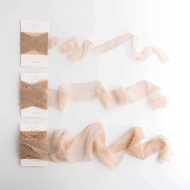 Tono + co Gossamer Silk Ribbon in Limited Edition Sand. Perfect for stationary styling, florals, and detail work. Find your inspiration through color and silk. Lovingly hand-dyed in Santa Ana, California and available in 24 signature colors. Check out our website for more styling, flat-lay, and color tips.