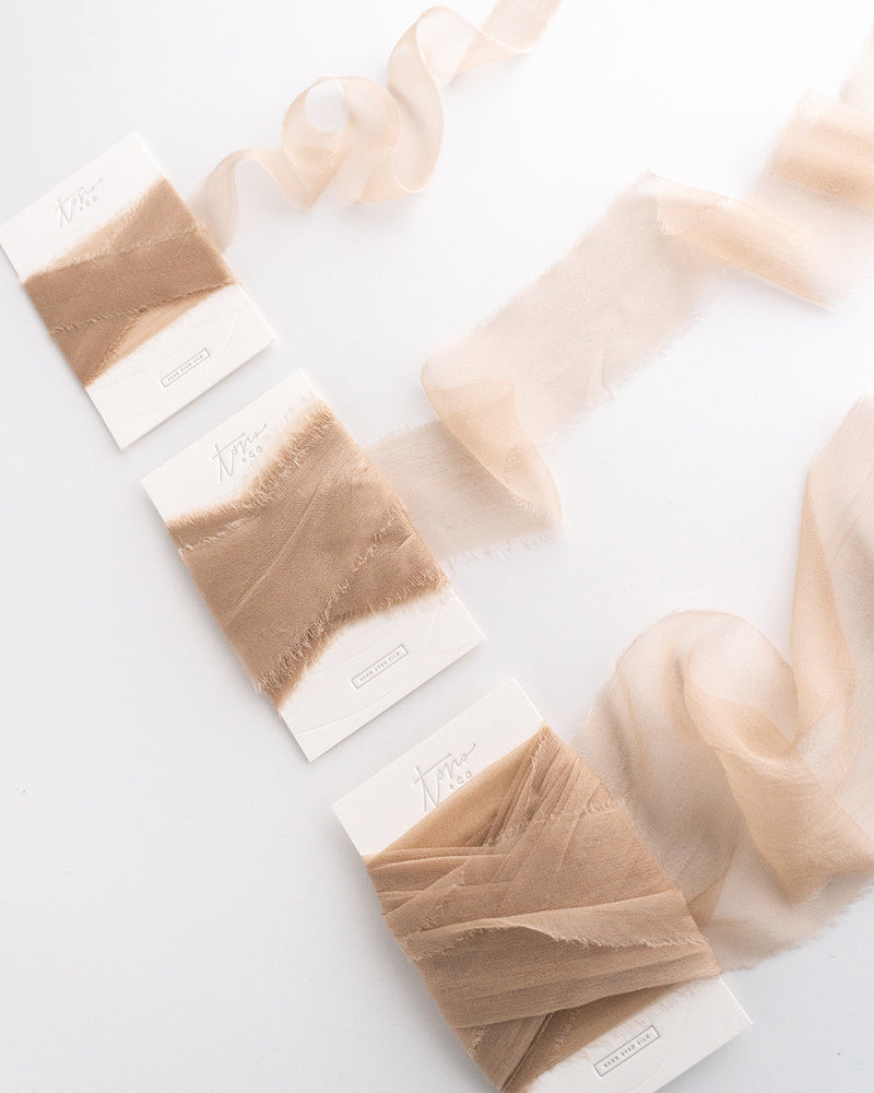 Tono + co Gossamer Silk Ribbon in Limited Edition Sand. Perfect for stationary styling, florals, and detail work. Find your inspiration through color and silk. Lovingly hand-dyed in Santa Ana, California and available in 24 signature colors. Check out our website for more styling, flat-lay, and color tips.