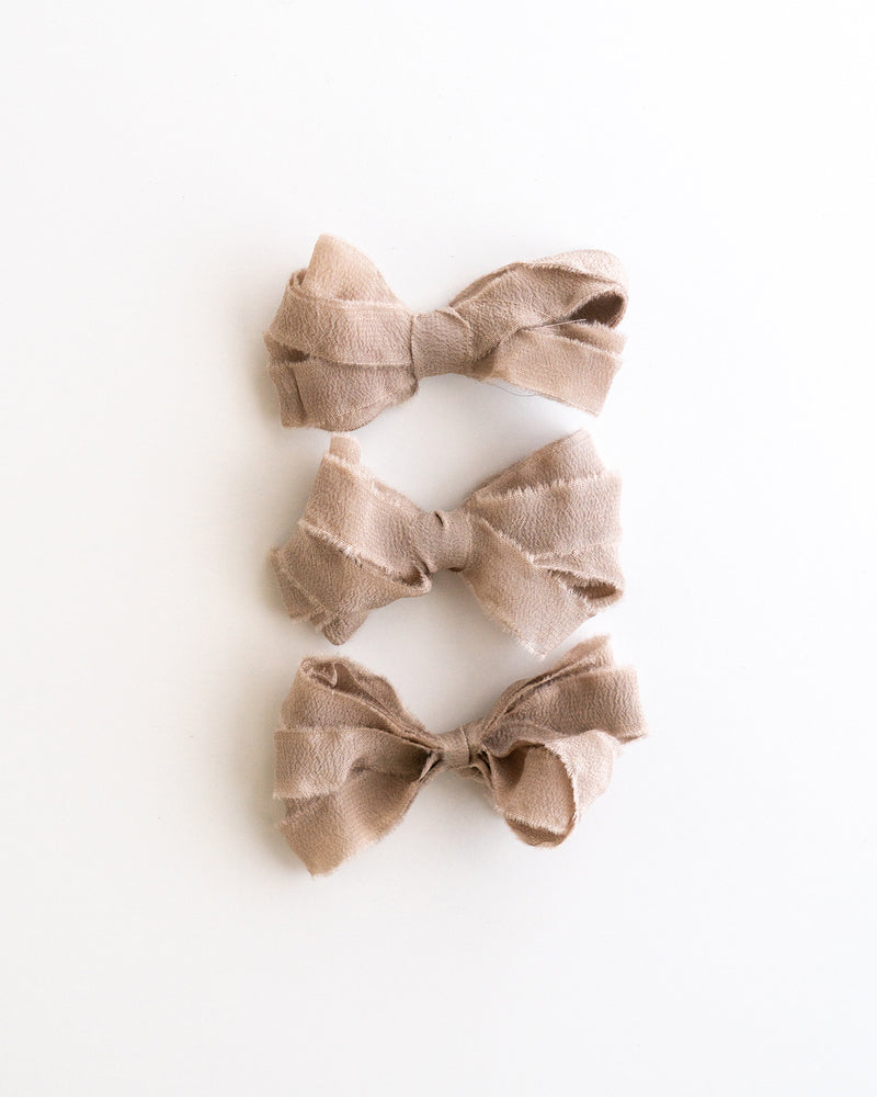 Tono + co Silk Ribbon Trim in Fawn. Perfect for stationary styling, boutonnieres, and detail work. Find your inspiration through color and silk. Lovingly hand-dyed in Santa Ana, California and available in 24 signature colors. Check out our website for more styling, flat-lay, and color tips.