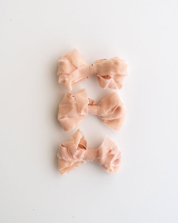 Tono + co Silk Ribbon Trim in Peach. Perfect for stationary styling, boutonnieres, and detail work. Find your inspiration through color and silk. Lovingly hand-dyed in Santa Ana, California and available in 24 signature colors. Check out our website for more styling, flat-lay, and color tips.