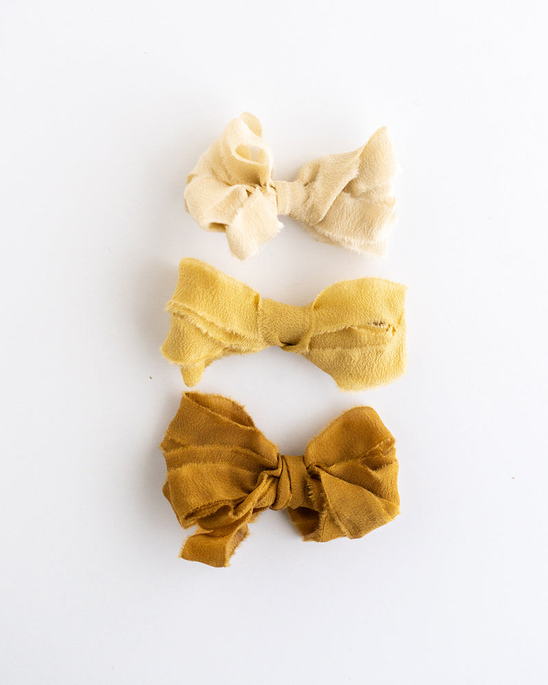 Tono + co Silk Ribbon Trim in the Golden Collection. Perfect for stationary styling, boutonnieres, and detail work. Find your inspiration through color and silk. Lovingly hand-dyed in Santa Ana, California and available in 24 signature colors. Check out our website for more styling, flat-lay, and color tips.